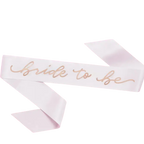 White bride to be sash with gold script for bridal shower from Parte Haus party supply store in Bethesda MD