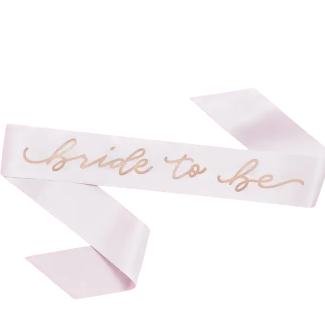 White bride to be sash with gold script for bridal shower from Parte Haus party supply store in Bethesda MD