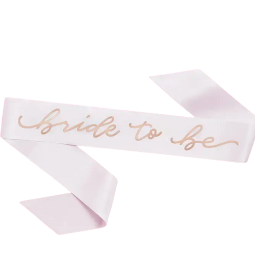 White bride to be sash with gold script for bridal shower from Parte Haus party supply store in Bethesda MD