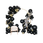 Black and gold balloon arch with cream chair modern event decor from Parte Haus party supply store in Bethesda Maryland