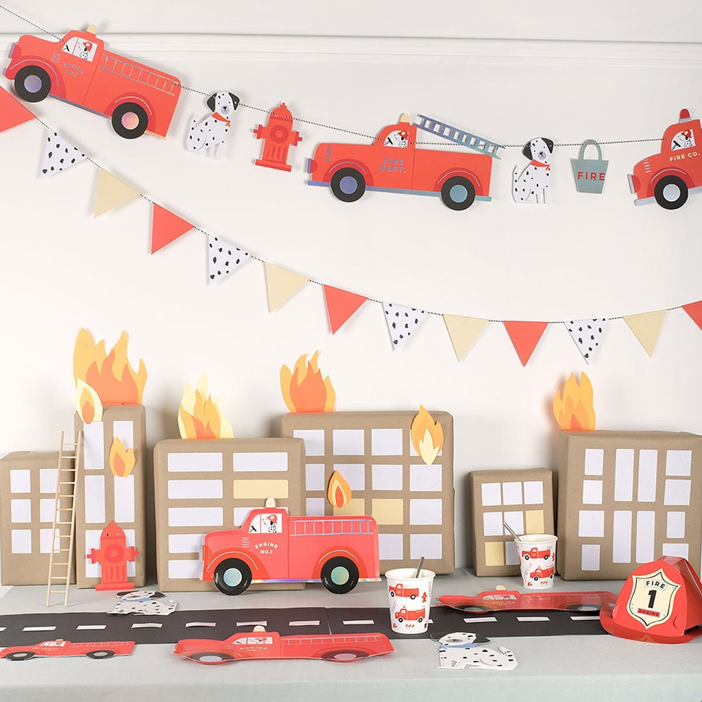 Red fire truck birthday decorations with flames and cityscape for kids party theme from Parte Haus party supply store in Bethesda MD