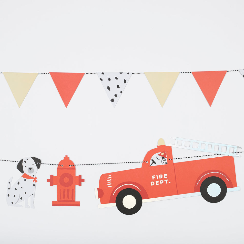 red and yellow firefighter garland with dalmatian dog fire truck fire hydrant birthday banner from Parte Haus party supply store in Bethesda MD
