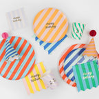 Colorful striped birthday plates napkins cups and hats for birthday celebration from Parte Haus party supply store in Bethesda MD.