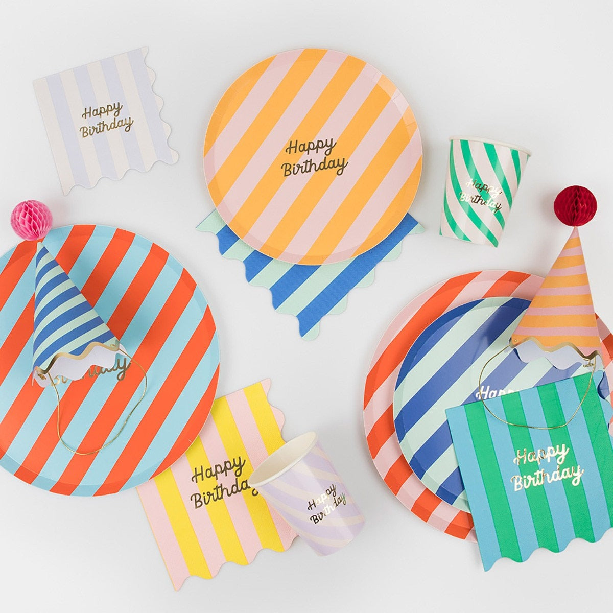 Colorful striped birthday plates napkins cups and hats for birthday celebration from Parte Haus party supply store in Bethesda MD.