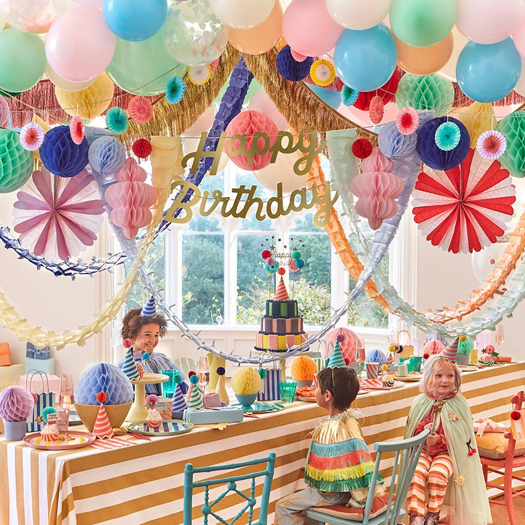 Colorful birthday decorations with balloons cake and kids at birthday celebration from Parte Haus party supply store in Bethesda Maryland