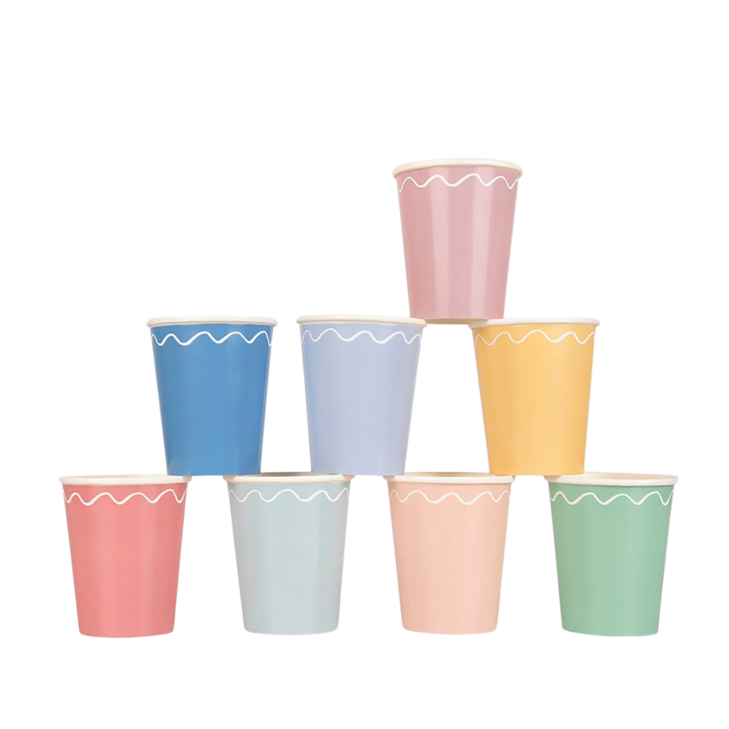 Pastel assorted paper cups with white scalloped trim stack birthday from Parte Haus party supply store in Bethesda Maryland
