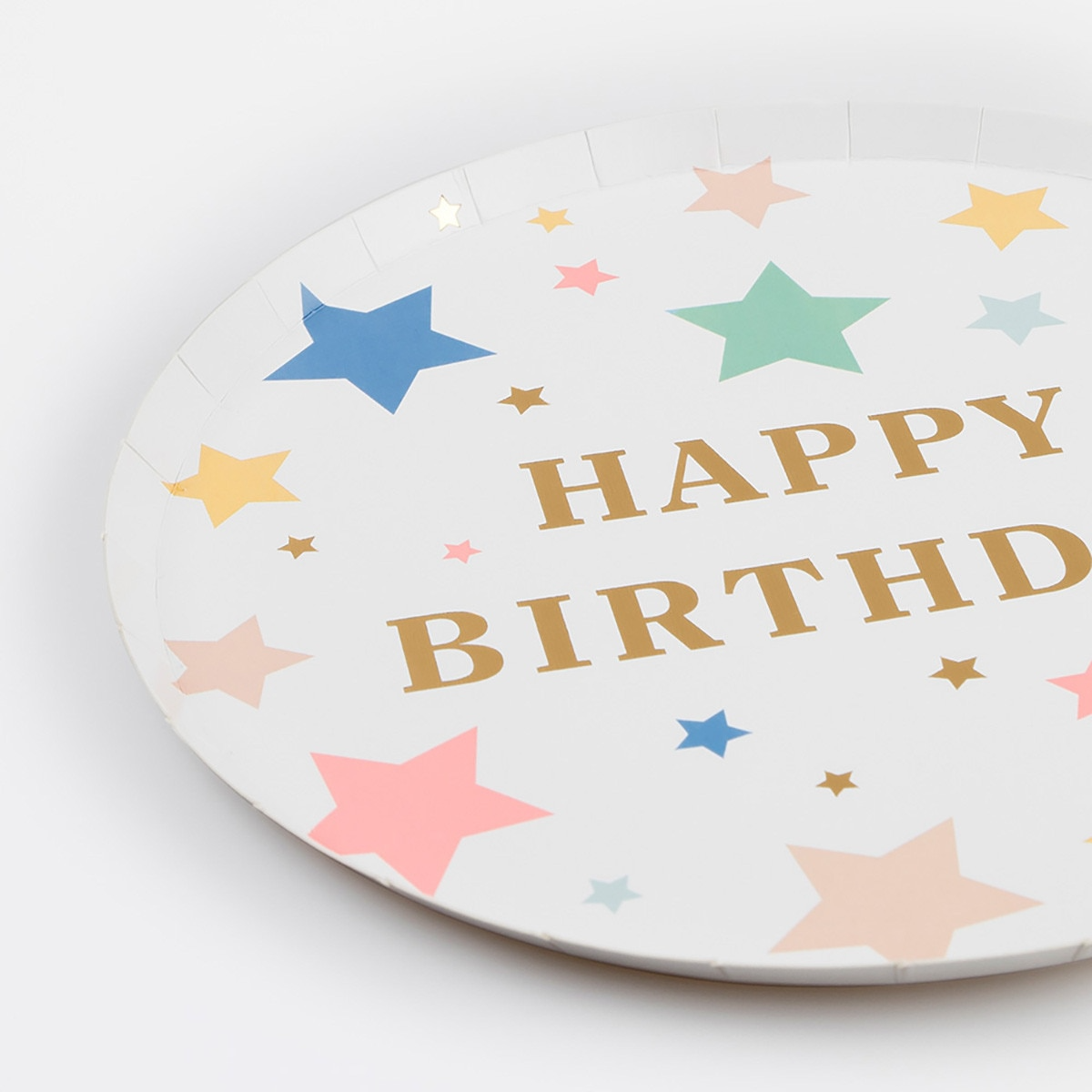 White happy birthday plate with colorful star print for birthday parties from Parte Haus party supply store in Bethesda Maryland