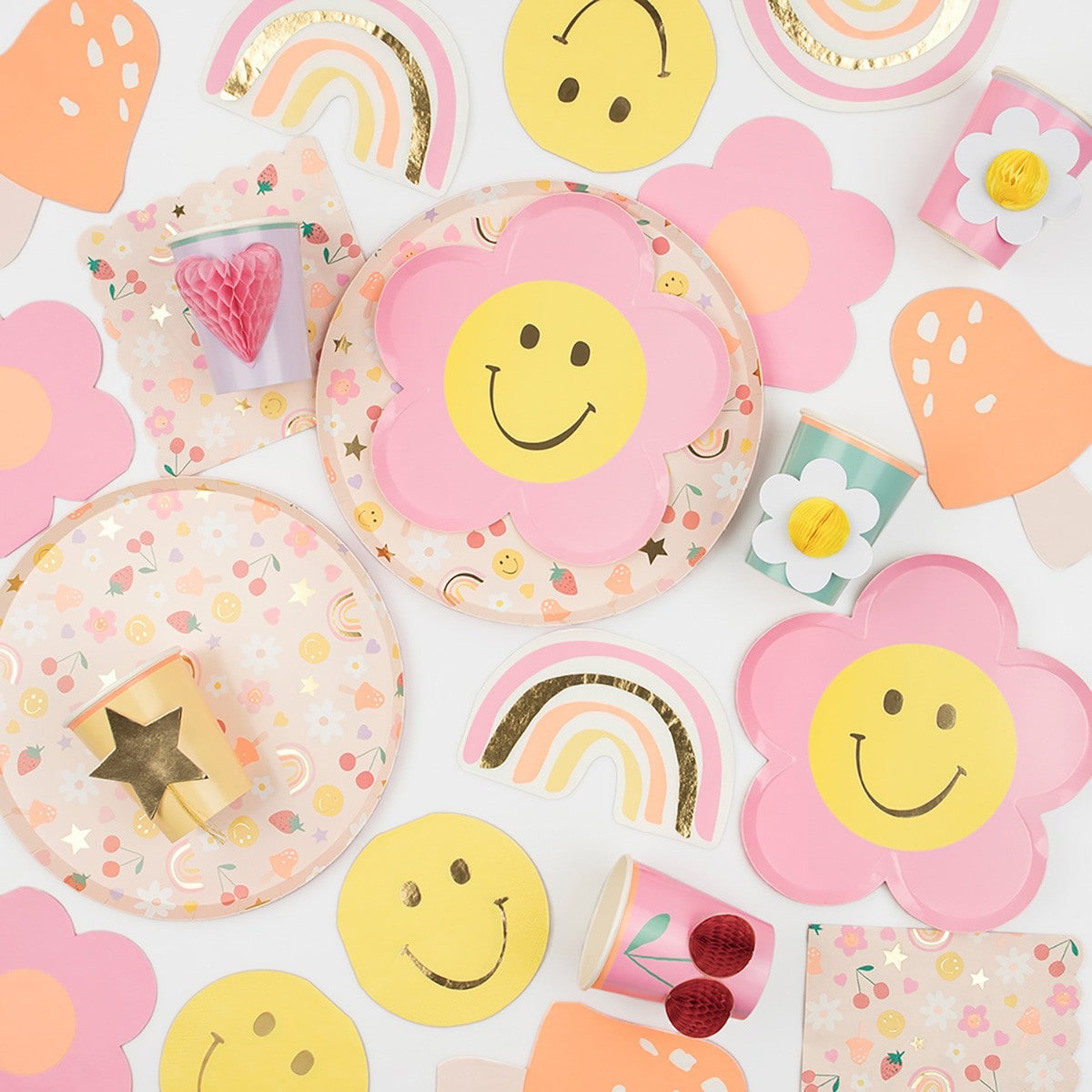 Pink yellow flower plates with smiley faces rainbows and pastel decorations birthday theme from Parte Haus party supply store in Bethesda MD