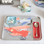 Red and blue airplane shaped plates on metal tray for kids birthday from Parte Haus party supply store in Bethesda Maryland