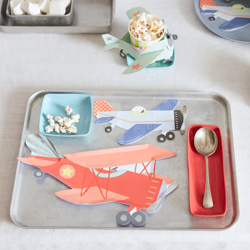 Red and blue airplane shaped plates on metal tray for kids birthday from Parte Haus party supply store in Bethesda Maryland