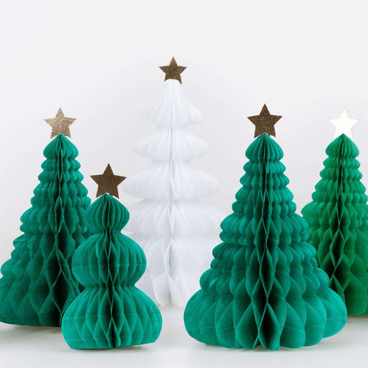 Green and white paper Christmas tree decorations with star toppers holiday decor from Parte Haus party supply store in Bethesda MD