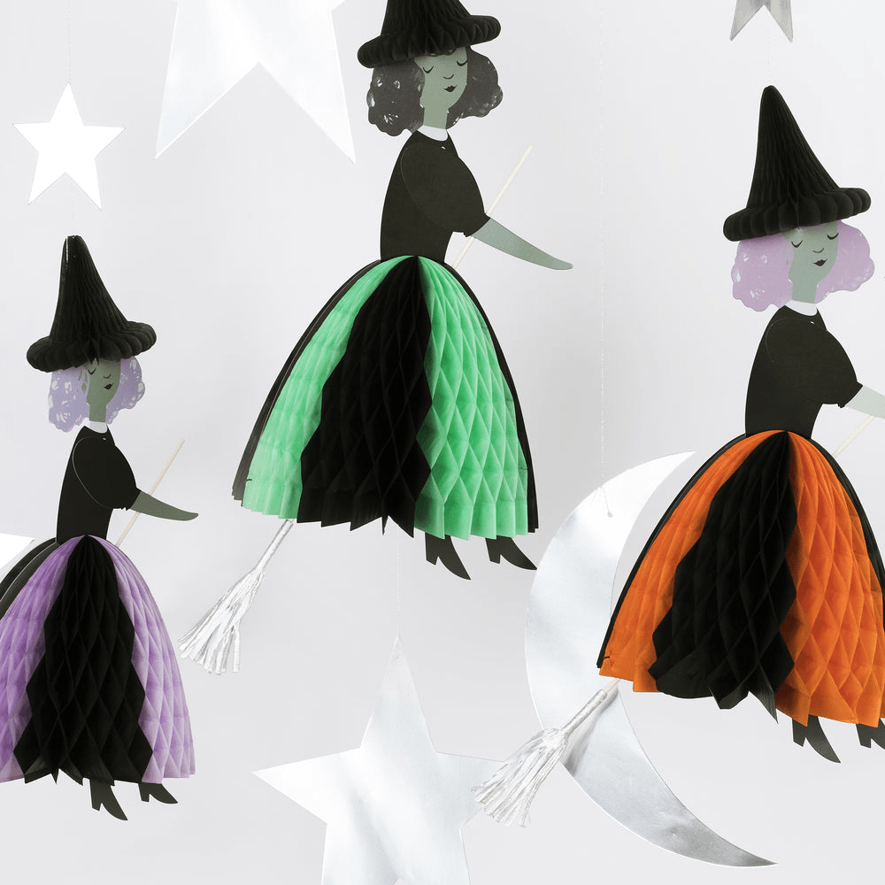 Green purple and orange witch paper decorations hanging for Halloween theme from Parte Haus party supply store in Bethesda MD