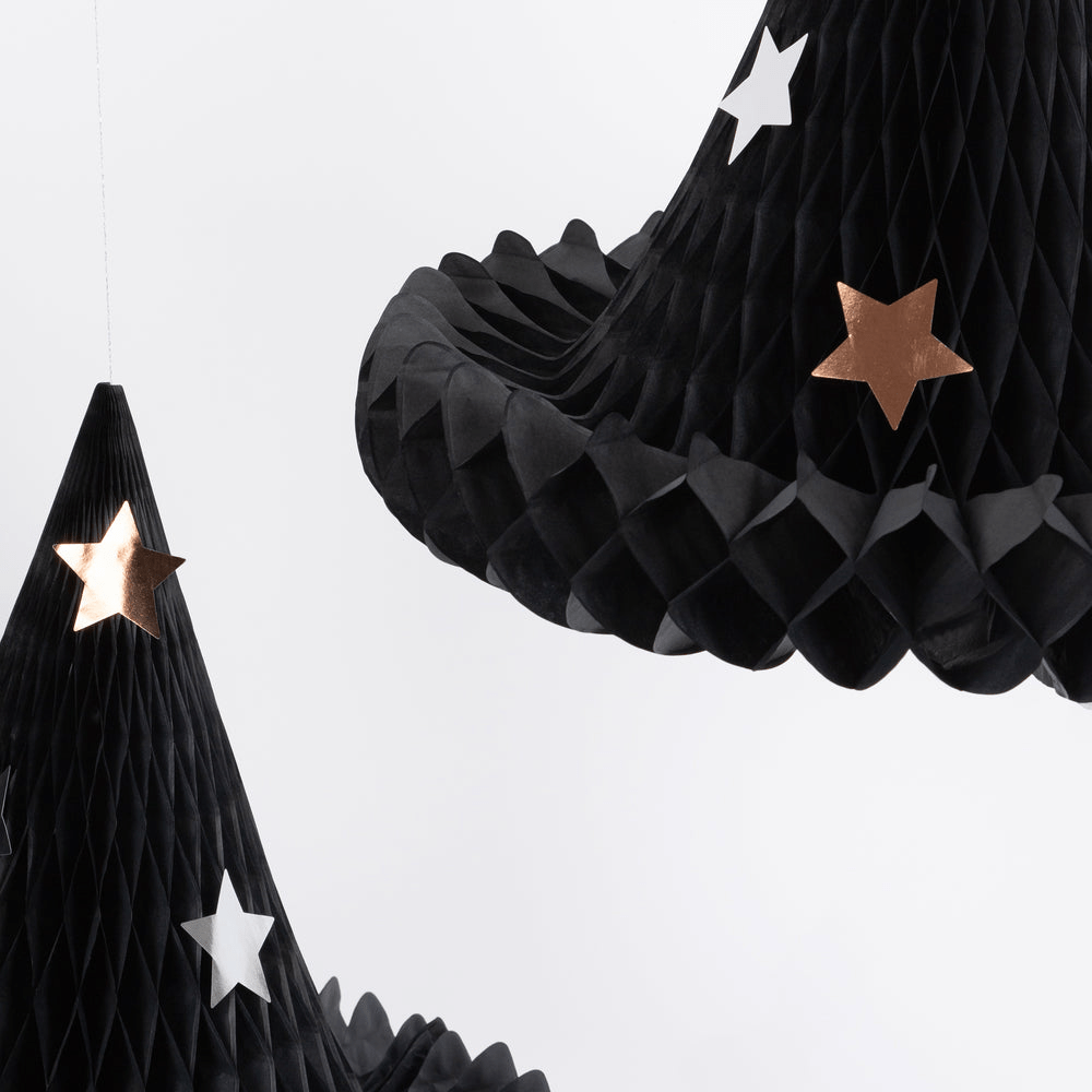 Black honeycomb paper witch hats with metallic and white stars Halloween decor from Parte Haus party supply store in Bethesda MD