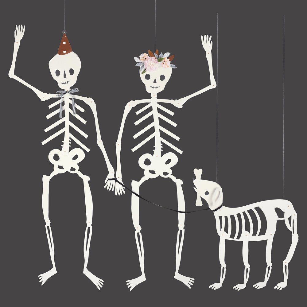 White skeleton family Halloween decorations with accessories for spooky theme from Parte Haus party supply store in Bethesda MD