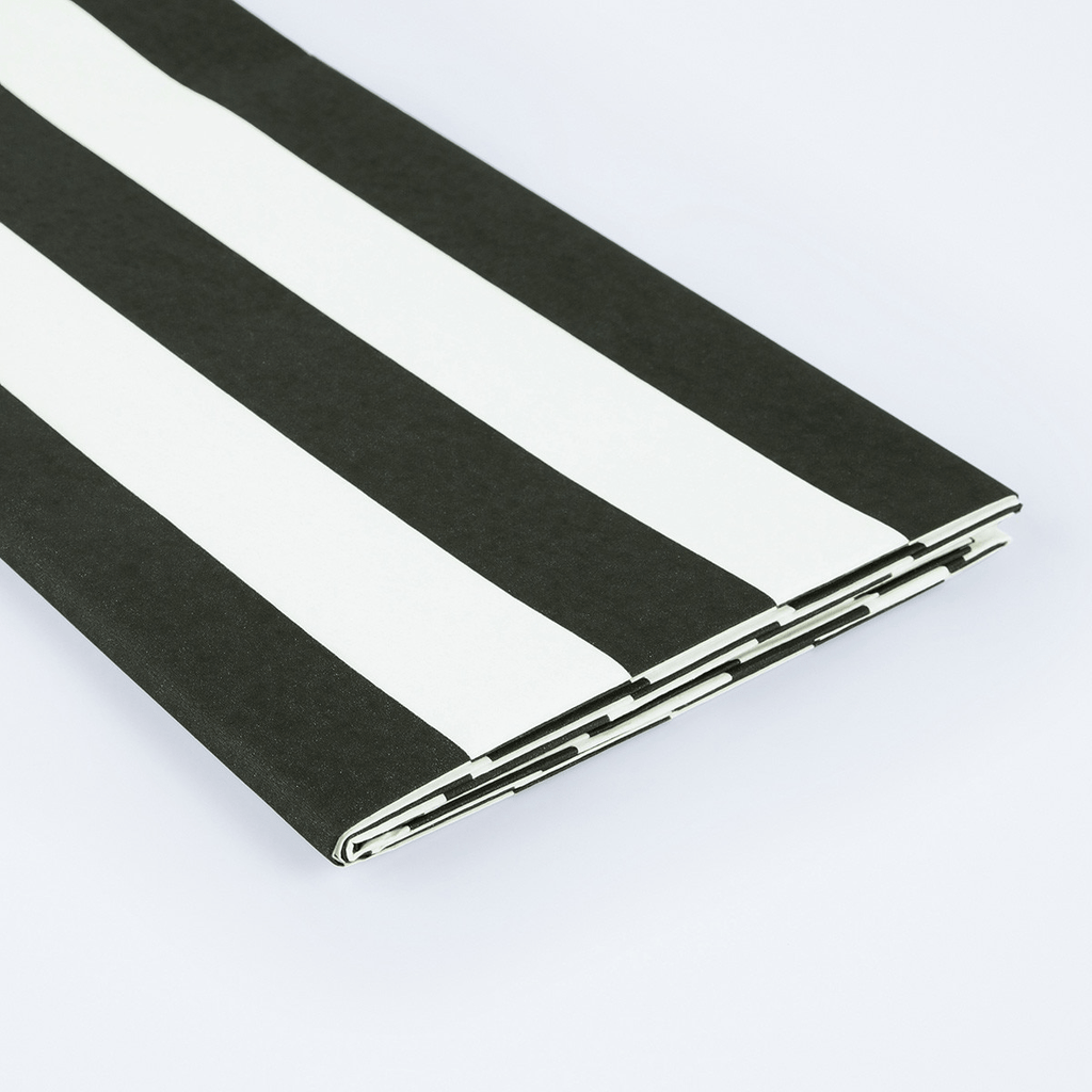 Black and white striped table cover folded for birthday from Parte Haus party supply store in Bethesda MD.