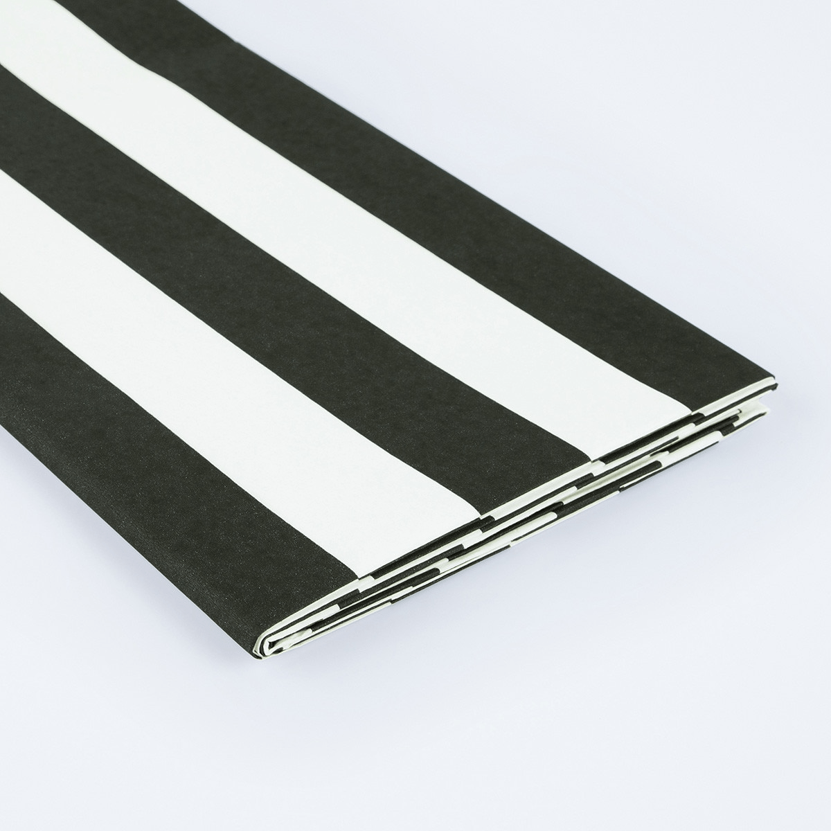 Black and white striped table cover folded for birthday from Parte Haus party supply store in Bethesda MD.