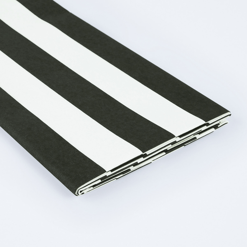 Black and white striped table cover folded for birthday from Parte Haus party supply store in Bethesda MD.