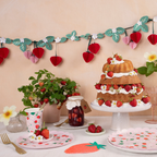 Red and pink strawberry garland with green leaves strawberry cake and floral summer table decor from Parte Haus party supply store in Bethesda MD