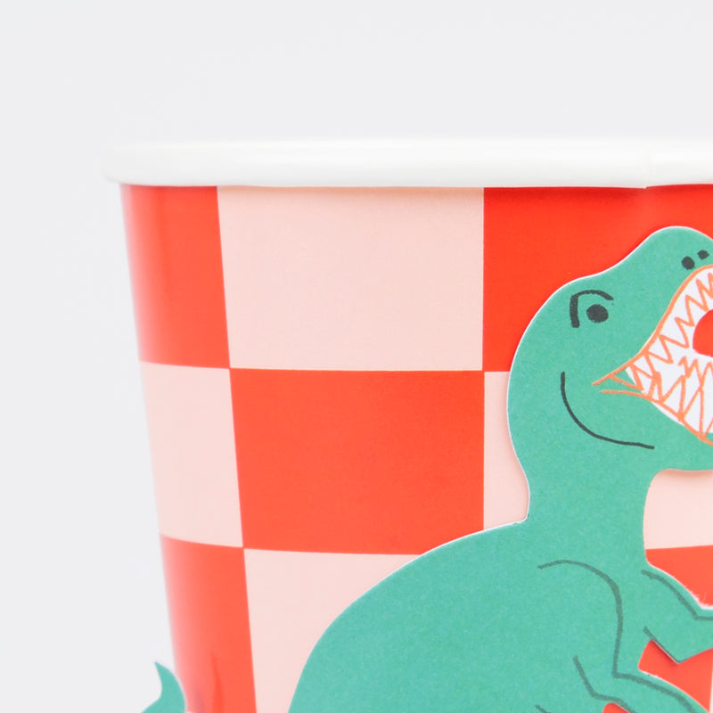 Red checkered paper cup with a green dinosaur cutout for kids birthday from Parte Haus party supply store in Bethesda Maryland
