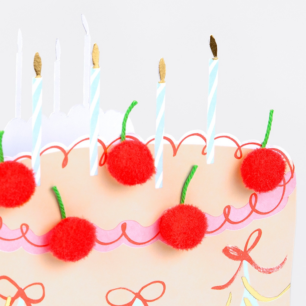Pink cake birthday card with red pompom cherries and candles for birthday from Parte Haus party supply store in Bethesda MD