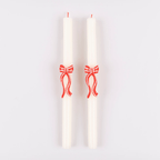 White taper candles with red bows festive decor from Parte Haus party supply store in Bethesda Maryland