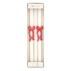 White taper candles with red bow accents perfect for holiday celebrations from Parte Haus party supply store in Bethesda MD