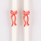 Red and white bow taper candles holiday decor from Parte Haus party supply store in Bethesda Maryland