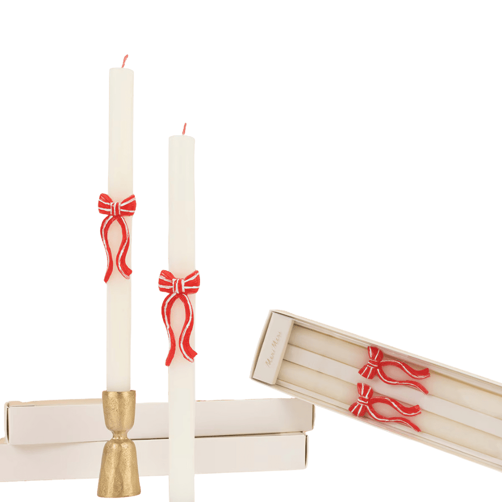 White taper candles with red bow accents holiday decor from Parte Haus party supply store in Bethesda Maryland