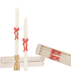 White taper candles with red bow accents holiday decor from Parte Haus party supply store in Bethesda Maryland
