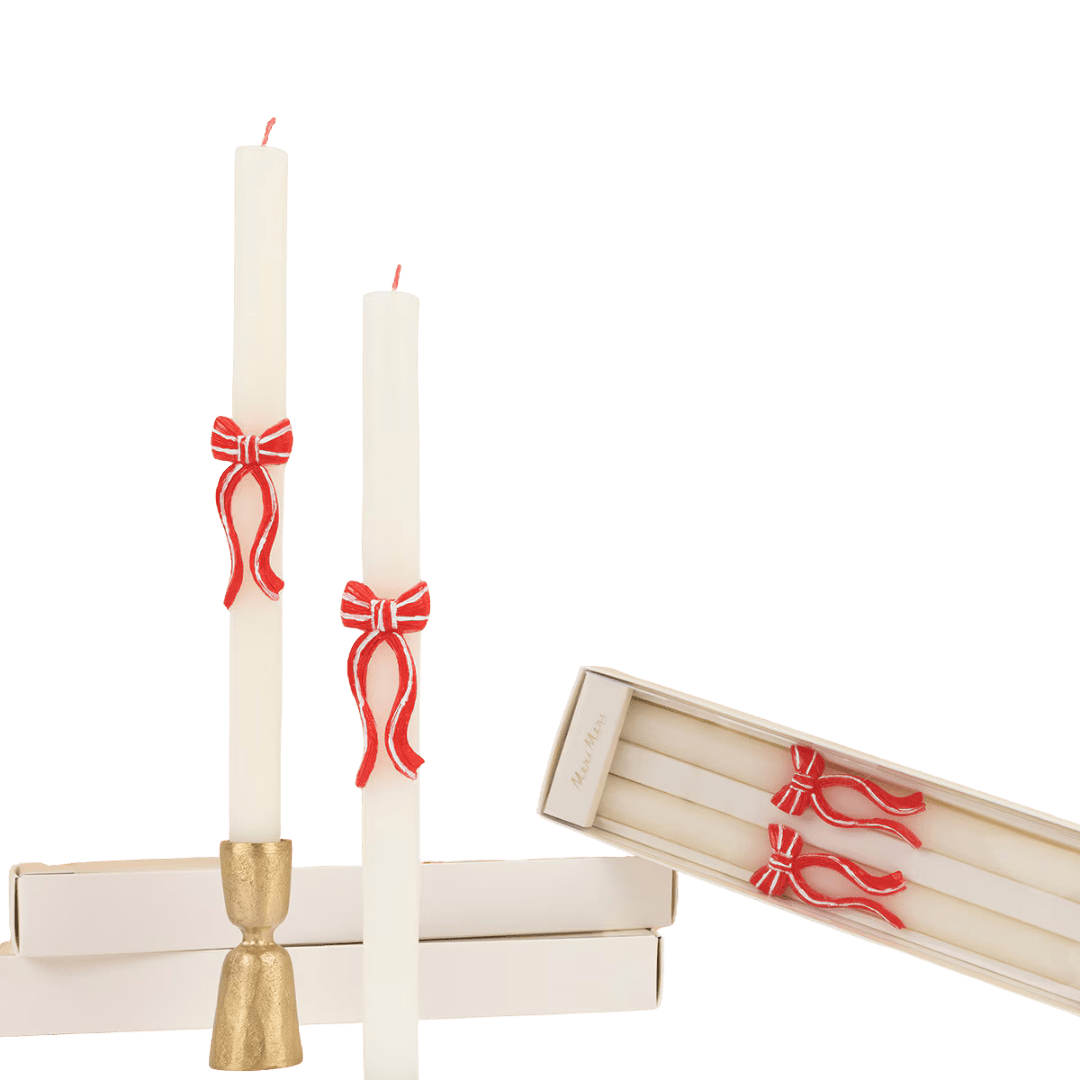White taper candles with red bow accents holiday decor from Parte Haus party supply store in Bethesda Maryland