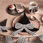 Black witch hat-shaped plate with striped bow Halloween table decor from Parte Haus party supply store in Bethesda MD