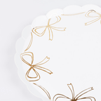 White and gold bow paper plate with scalloped edges for birthday theme from Parte Haus party supply store in Bethesda MD