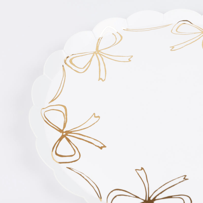 White and gold bow paper plate with scalloped edges for birthday theme from Parte Haus party supply store in Bethesda MD
