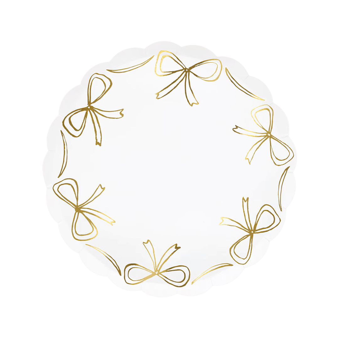White scalloped plate with gold bows elegant tableware for birthday from Parte Haus party supply store in Bethesda MD.