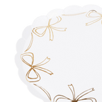 White and gold scalloped plate with bow accents for celebration from Parte Haus party supply store in Bethesda Maryland