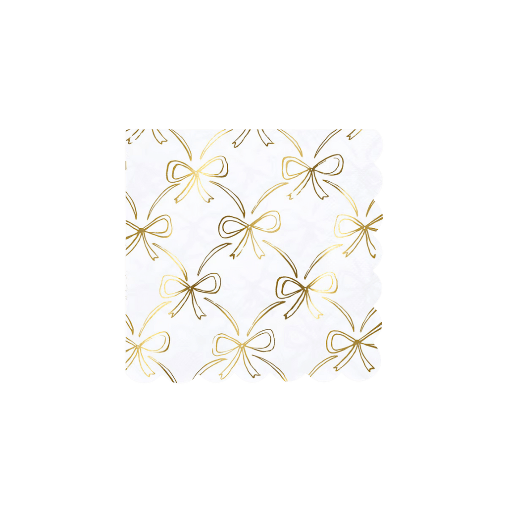 White and gold bow napkin with scalloped edges elegant table decor for birthday celebration from Parte Haus party supply store in Bethesda MD