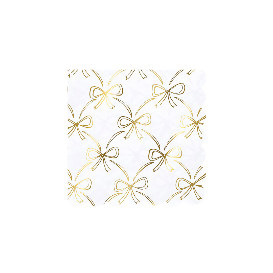 White and gold bow napkin with scalloped edges elegant table decor for birthday celebration from Parte Haus party supply store in Bethesda MD