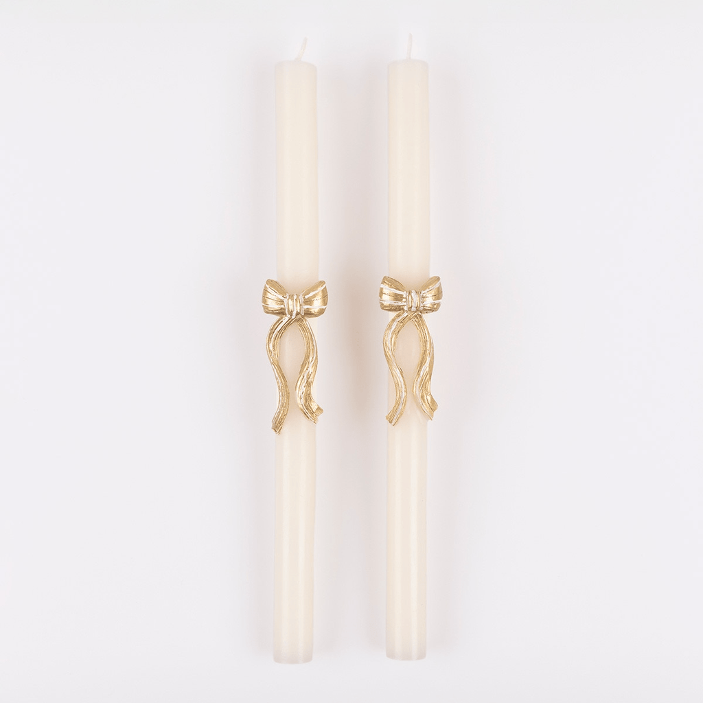 Ivory taper candles with gold bow accent for elegant dinner celebrations from Parte Haus party supply store in Bethesda MD