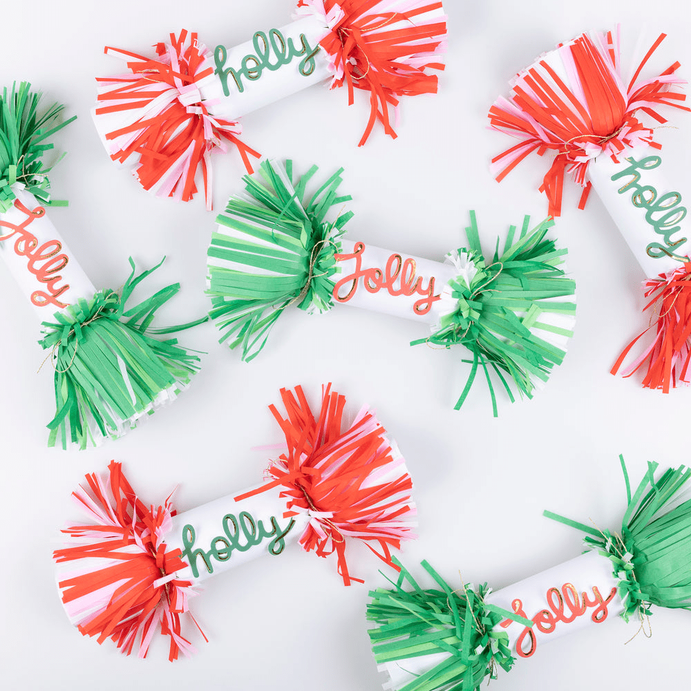 Red and green Christmas crackers with fringe ends and holly jolly text from Parte Haus party supply store in Bethesda MD