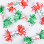 Red and green Christmas crackers with fringe ends and holly jolly text from Parte Haus party supply store in Bethesda MD