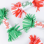 Green and red Christmas crackers with holly jolly script from Parte Haus party supply store in Bethesda Maryland