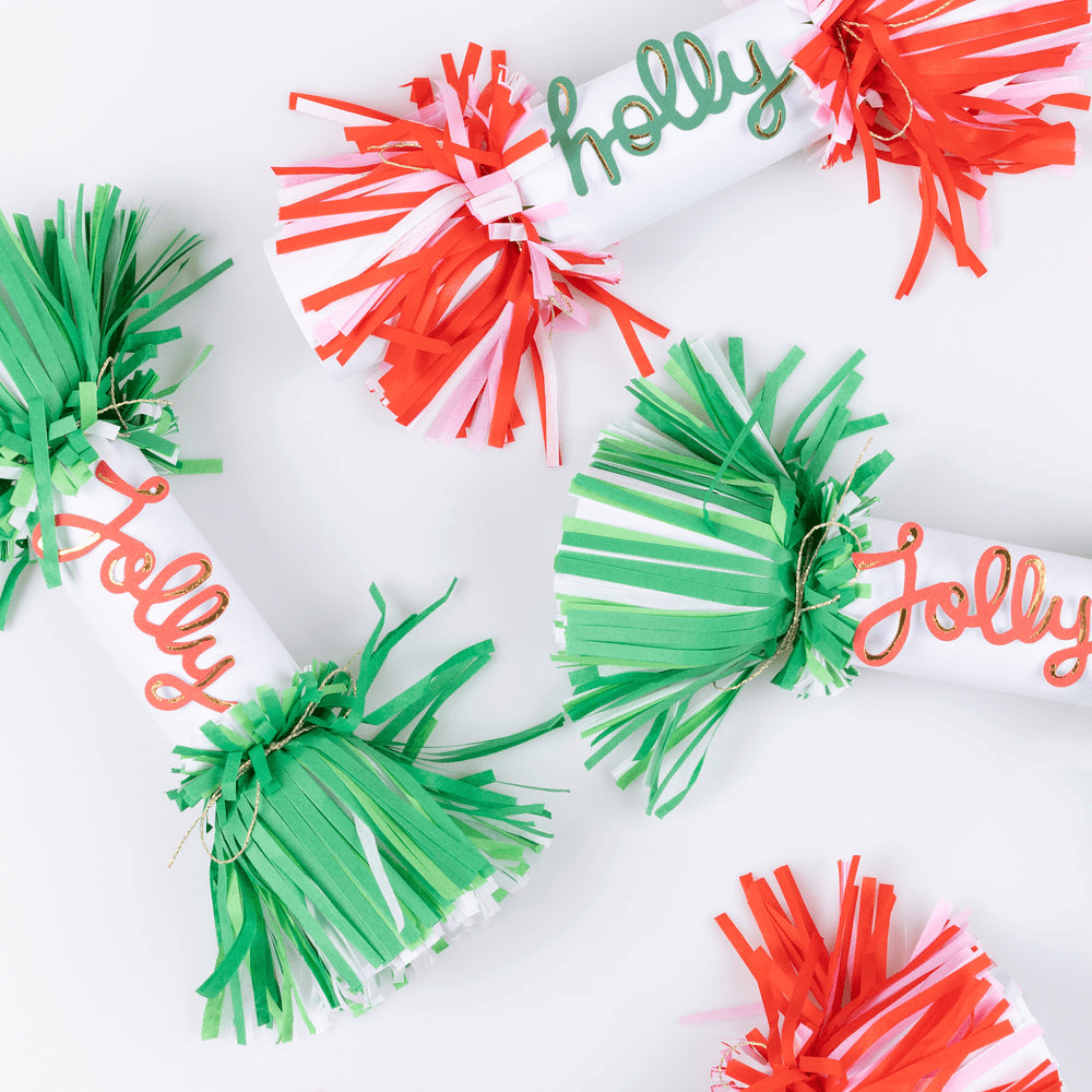 Green and red Christmas crackers with holly jolly script from Parte Haus party supply store in Bethesda Maryland