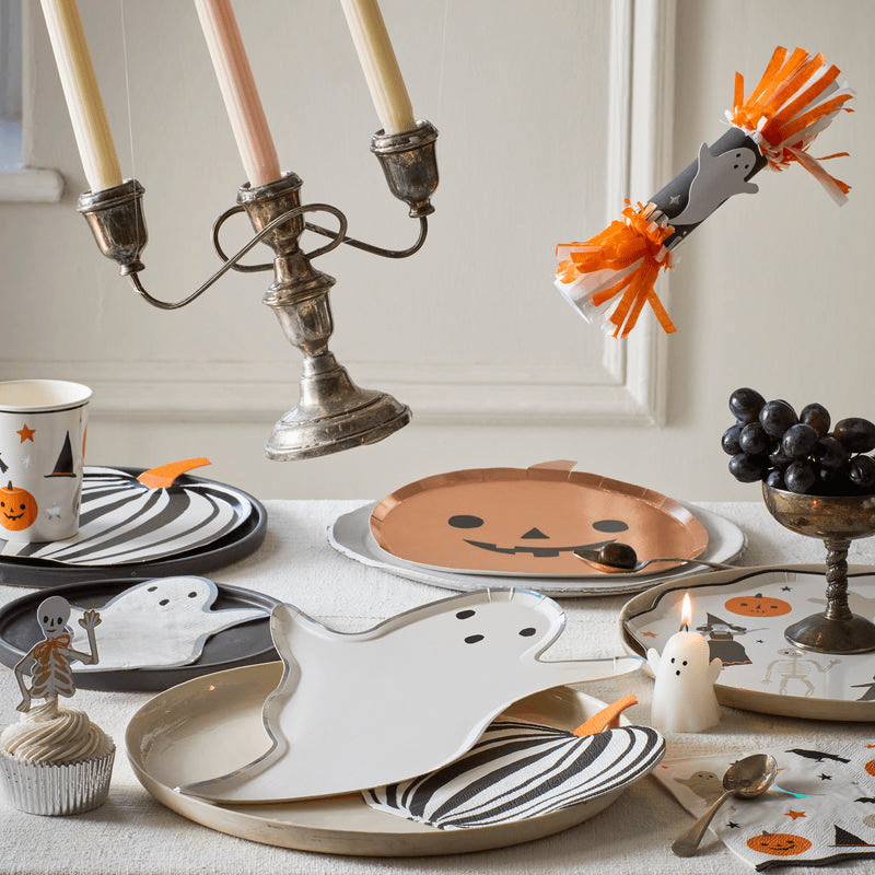 White and orange Halloween ghost and pumpkin tableware with candles for Halloween from Parte Haus party supply store in Bethesda MD