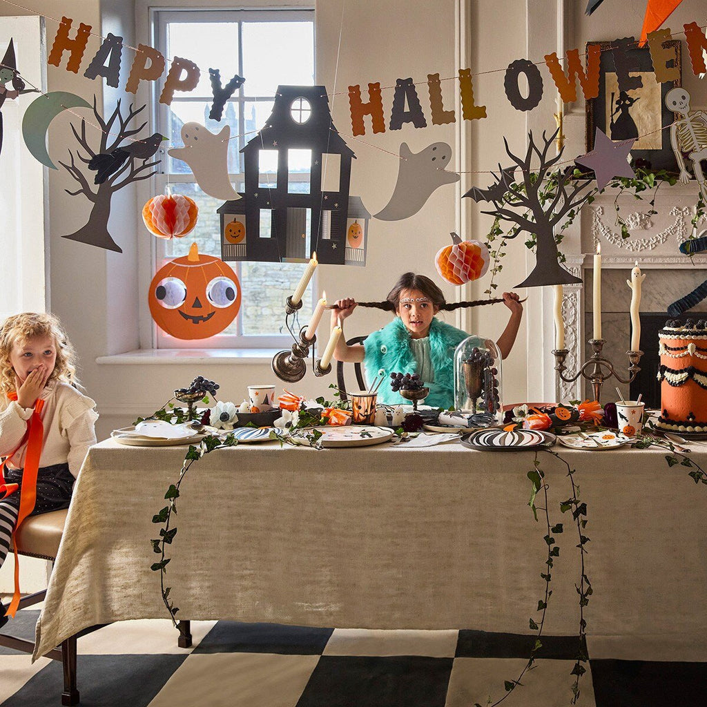 Colorful Halloween table decorations with ghosts pumpkins bats at kids party from Parte Haus party supply store in Bethesda MD