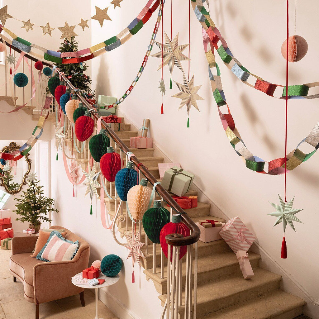 Multicolor Christmas garlands and ornaments decorate a staircase holiday decor from Parte Haus party supply store in Bethesda MD.