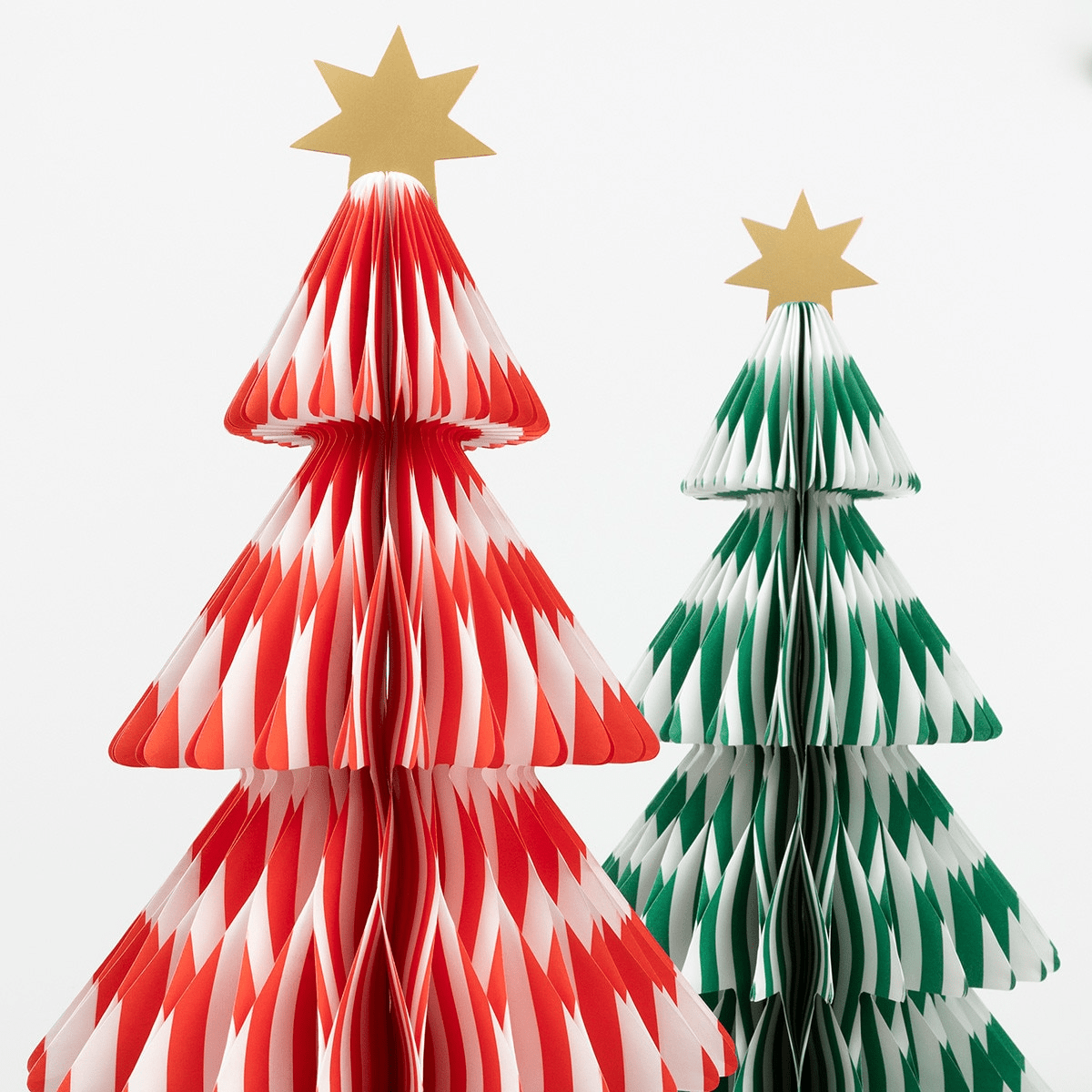 Red and green paper Christmas tree decorations with gold star toppers for holiday from Parte Haus party supply store in Bethesda Maryland