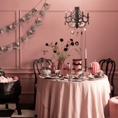 pink and black Halloween table decorations with striped banners and pumpkins party display from Parte Haus party supply store in Bethesda Maryland