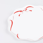 Red and white scalloped paper plate with ribbon design birthday from Parte Haus party supply store in Bethesda Maryland