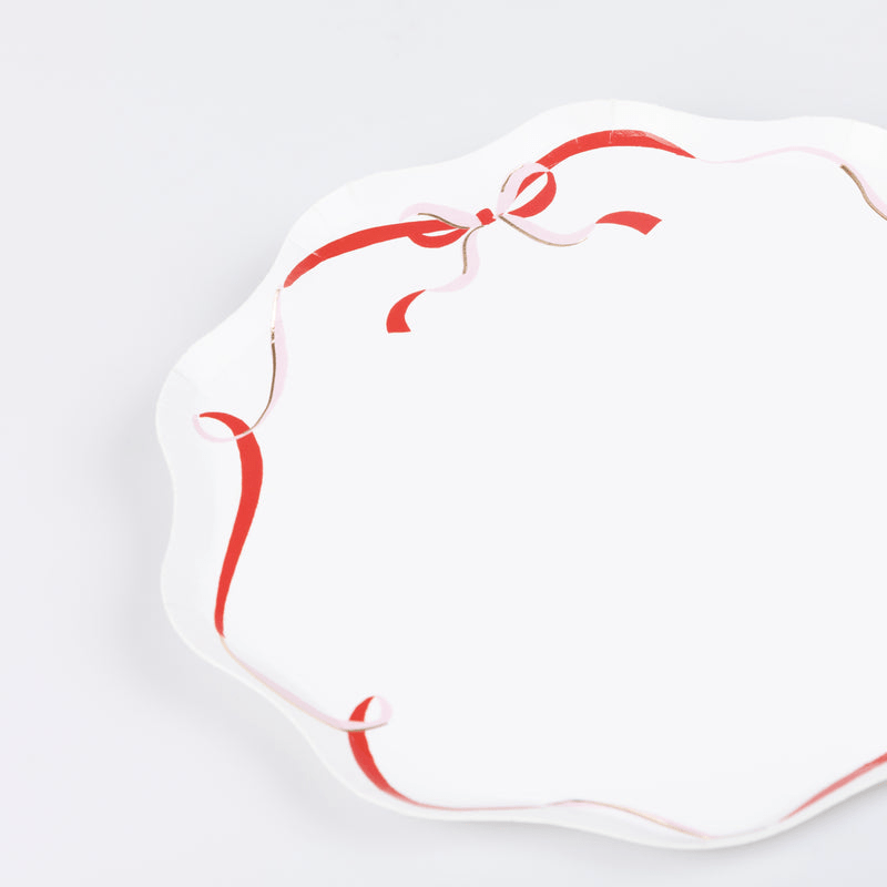 Red and white scalloped paper plate with ribbon design birthday from Parte Haus party supply store in Bethesda Maryland