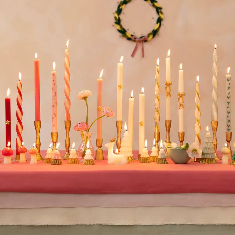 Pink and white spiral taper candles in gold holders for holiday table decor from Parte Haus party supply store in Bethesda MD